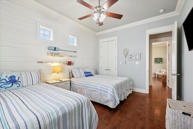 2904 Shady Ln, Crystal Beach, TX 77650 - bedroom featuring dark wood-type flooring, ornamental molding, a closet, and ceiling fan