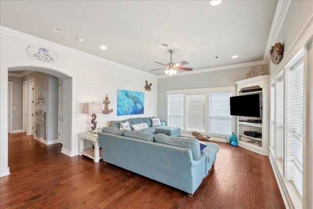 2904 Shady Ln, Crystal Beach, TX 77650 - living room with dark wood-type flooring, ornamental molding, and ceiling fan