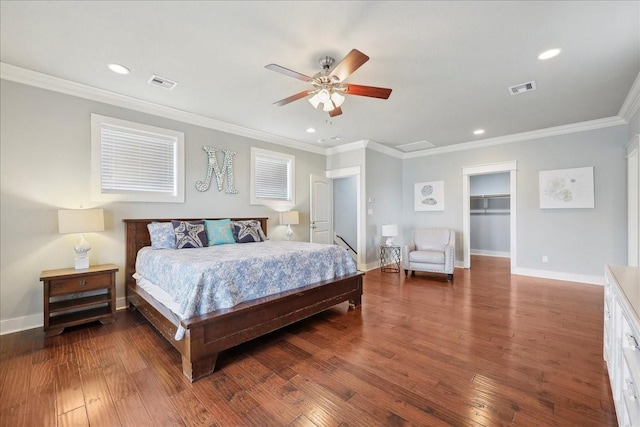 2904 Shady Ln, Crystal Beach, TX 77650 - bedroom with dark wood-type flooring, ceiling fan, ornamental molding, and a walk in closet