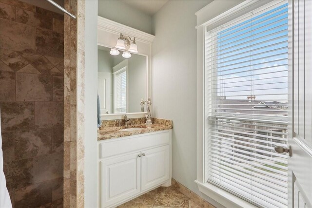 2904 Shady Ln, Crystal Beach, TX 77650 - bathroom with vanity, tile patterned flooring, and a tile shower