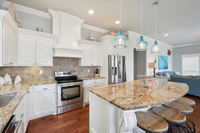 2904 Shady Ln, Crystal Beach, TX 77650 - kitchen with pendant lighting, white cabinetry, stainless steel appliances, and custom range hood