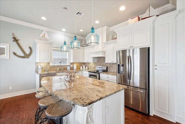 2904 Shady Ln, Crystal Beach, TX 77650 - kitchen featuring a kitchen island, pendant lighting, white cabinets, stainless steel appliances, and light stone countertops