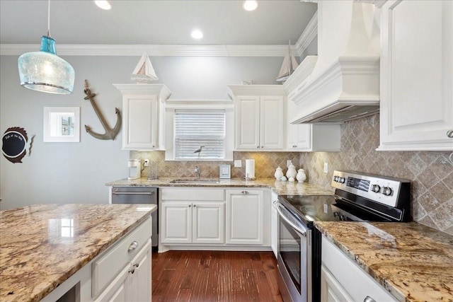 2904 Shady Ln, Crystal Beach, TX 77650 - kitchen with white cabinetry, appliances with stainless steel finishes, premium range hood, and decorative light fixtures
