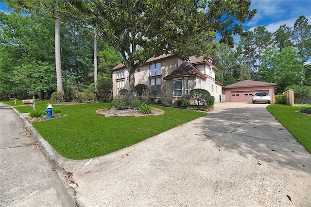 view of front of home with stone siding, a detached garage, and a front lawn