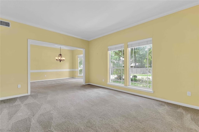 carpeted spare room with a chandelier, a healthy amount of sunlight, visible vents, and ornamental molding