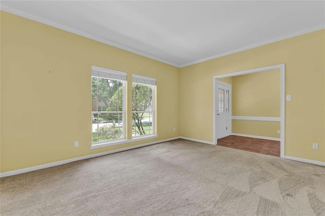 unfurnished room with carpet floors, baseboards, and ornamental molding