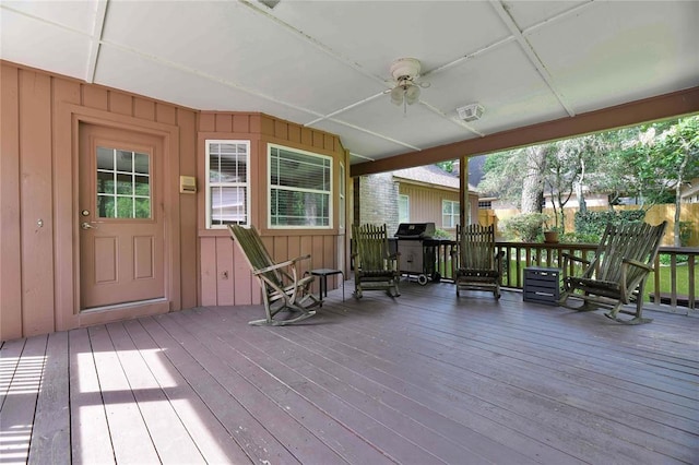 wooden terrace featuring a ceiling fan