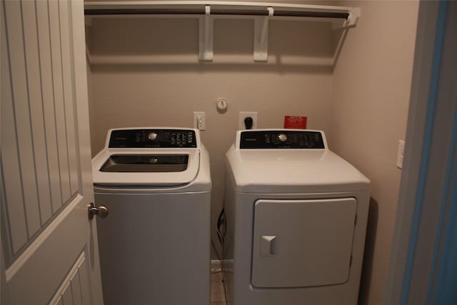 clothes washing area featuring washing machine and clothes dryer