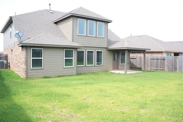 rear view of house featuring a patio area and a lawn