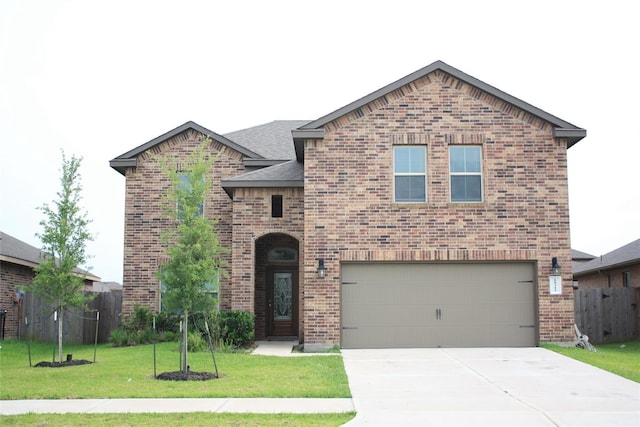 front of property with a garage and a front lawn