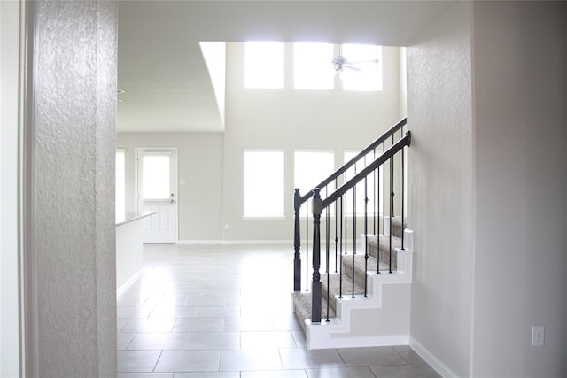 tiled foyer entrance featuring ceiling fan