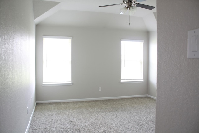 carpeted empty room featuring a wealth of natural light and ceiling fan