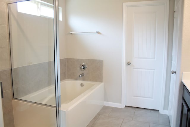 bathroom with vanity, tile patterned floors, and a tub