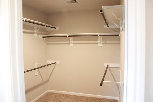 walk in closet with carpet