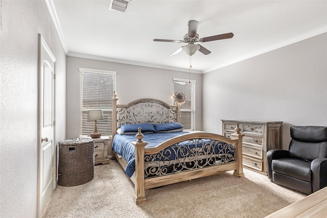 carpeted bedroom with ceiling fan, ornamental molding, and multiple windows