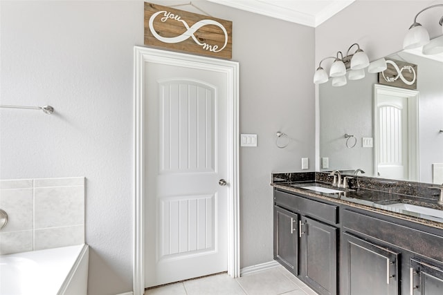 bathroom featuring vanity, tile patterned floors, ornamental molding, and a tub