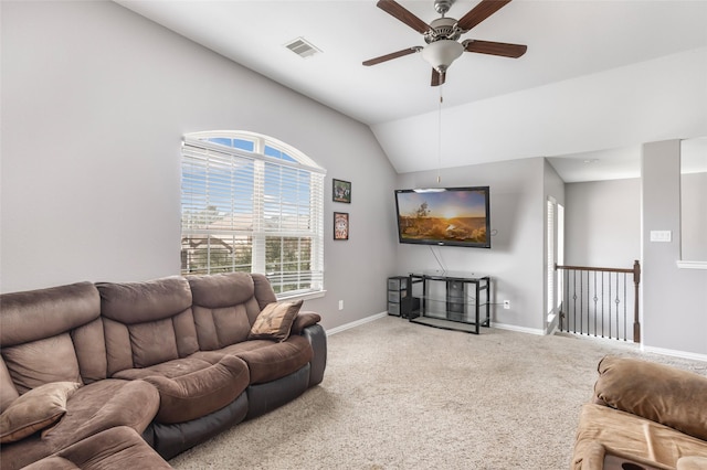 living room featuring ceiling fan, carpet flooring, and vaulted ceiling