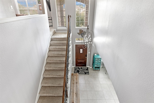 stairs featuring tile patterned flooring and plenty of natural light