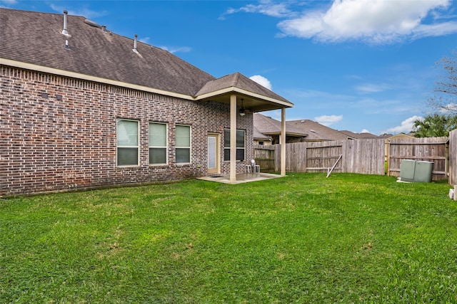 rear view of house featuring a patio and a yard