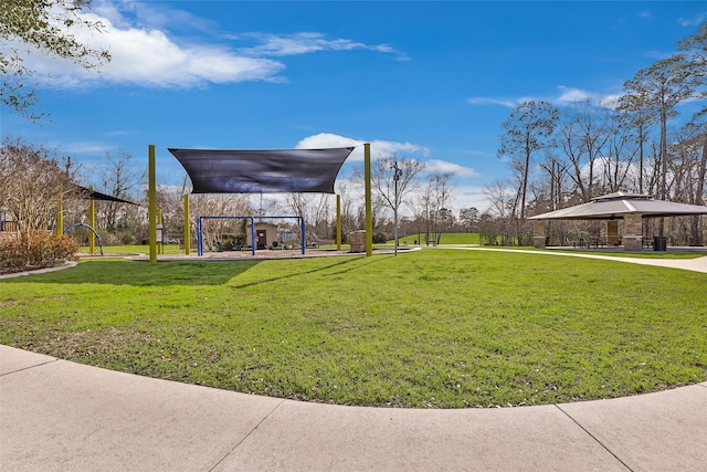 surrounding community with a gazebo and a yard