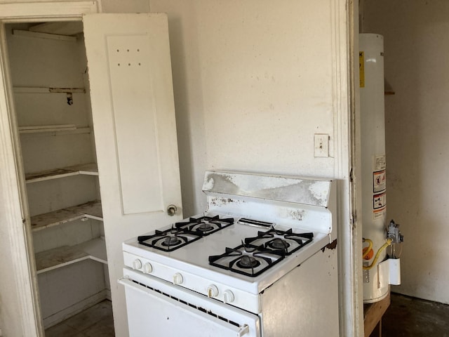 kitchen featuring water heater and gas range gas stove