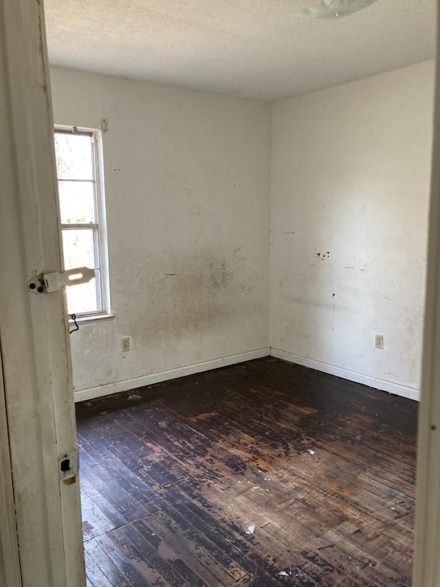 empty room featuring dark hardwood / wood-style flooring