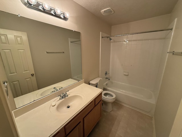 full bathroom with vanity, tub / shower combination, a textured ceiling, and toilet