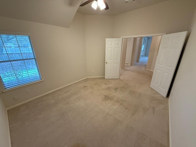 unfurnished bedroom featuring light colored carpet and ceiling fan