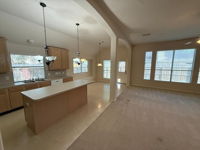 kitchen featuring a wealth of natural light, lofted ceiling, sink, a chandelier, and a center island