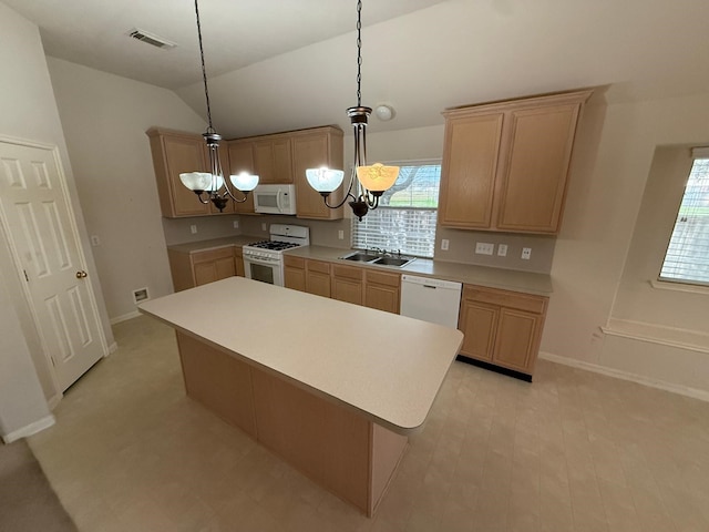 kitchen featuring pendant lighting, sink, white appliances, a notable chandelier, and a kitchen island