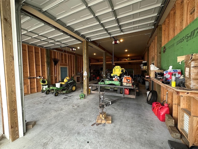 garage with a garage door opener and a workshop area