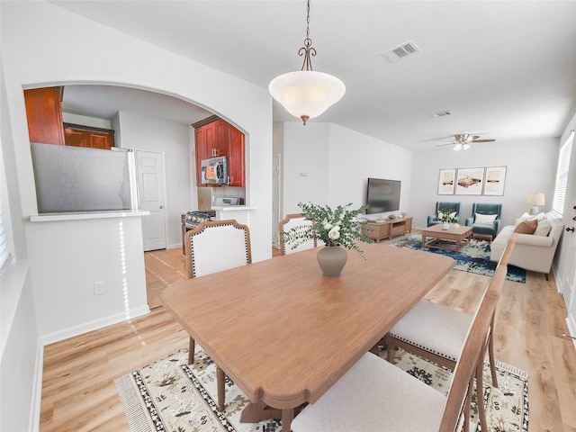 dining space featuring ceiling fan and light wood-type flooring