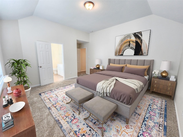 bedroom featuring carpet floors, ensuite bath, and vaulted ceiling