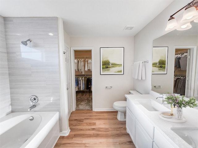 full bathroom featuring vanity, toilet, separate shower and tub, and wood-type flooring