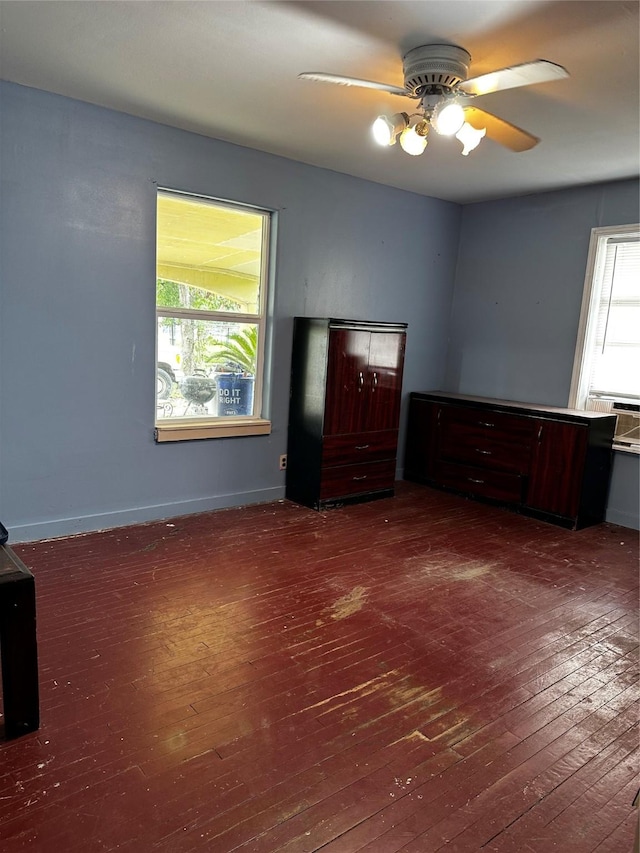 unfurnished bedroom with dark hardwood / wood-style floors and ceiling fan