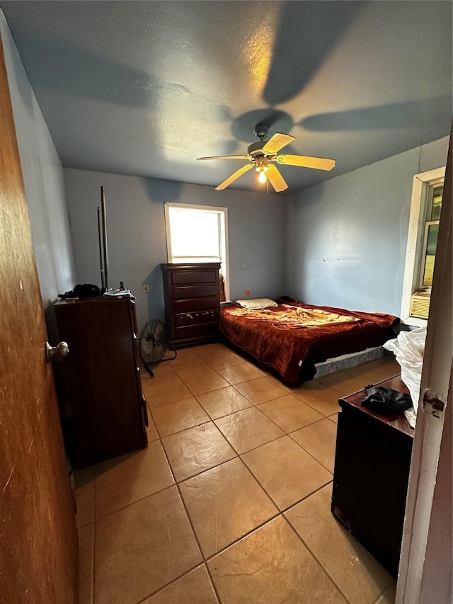 bedroom with ceiling fan and light tile patterned floors