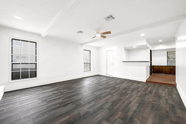 unfurnished living room featuring dark wood-style floors, baseboards, visible vents, and beam ceiling