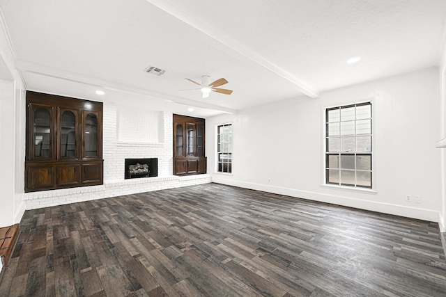 unfurnished living room featuring a fireplace, visible vents, wood finished floors, beamed ceiling, and baseboards