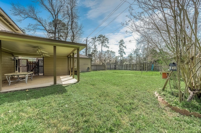 view of yard with ceiling fan, a patio, and a fenced backyard