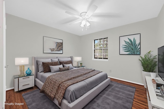 bedroom with a ceiling fan, dark wood finished floors, and baseboards