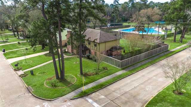 view of community with fence and a yard