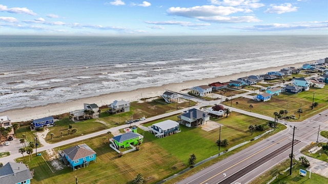 aerial view with a water view and a beach view