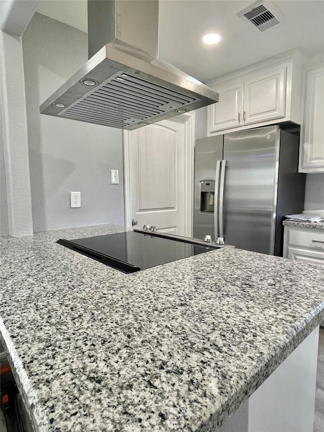 kitchen with white cabinetry, island exhaust hood, kitchen peninsula, and stainless steel fridge with ice dispenser