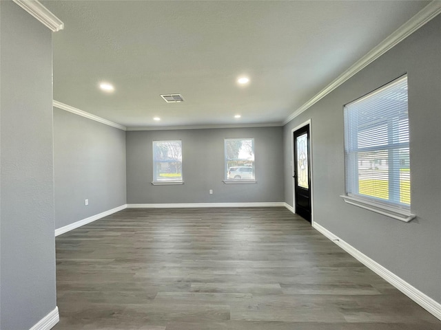 spare room with wood-type flooring and ornamental molding