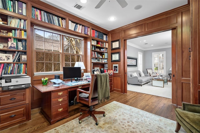 office area featuring ornamental molding, a ceiling fan, visible vents, and wood finished floors