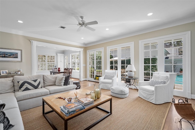 living room featuring ornamental molding, recessed lighting, french doors, and wood finished floors