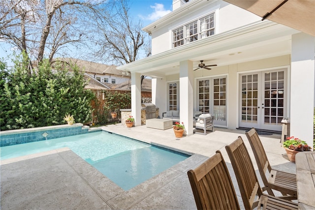 pool with french doors, area for grilling, a patio area, ceiling fan, and fence