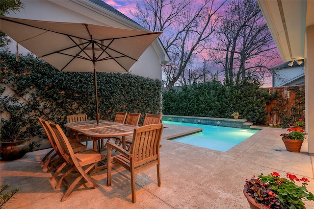 view of swimming pool with a fenced in pool, outdoor dining area, and a patio area