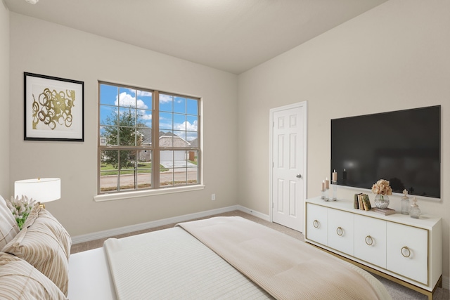 bedroom featuring light carpet