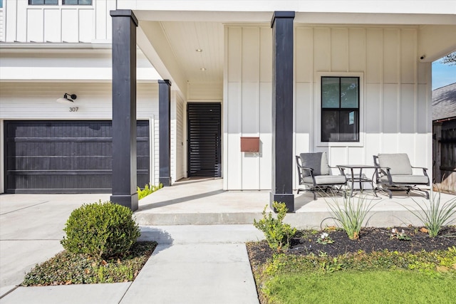 property entrance featuring a porch and a garage